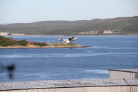 MBR-1936.jpg (140.32 КБ) 71972 просмотра Открыт на о. Большой Грязный в Кольском заливе 29 октября 1968 г.<br />Остров, на котором расположен памятник, находится примерно на полпути от Мурманска до Североморска. На каменном фундаменте с цифрами "1936" стоит старый гидросамолет. Он напоминает о том, как в сентябре 1936г. в трюмах кораблей в ящиках прибыло сюда звено - три первых гидросамолета-разведчика "МБР-2". Здесь их собрали, здесь они впервые поднялись в заполярное небо и начали осваивать район полетов. Первым командиром звена был ст. лейтенант Г.В.Степанов. На базе этого звена со временем образовался морской разведывательный полк не раз отличавшийся в годы Великой Отечественной войны". В составе полка служил и гидросамолет, ставший памятником. Первым его пилотом и командиром экипажа долго был Л.И.Анифер. После войны этот гидросамолет стал летать на ледовую разведку в Арктику. Свой последний полет "МБР-2" совершил в мае 1963 года. Через несколько месяцев он стал памятником.